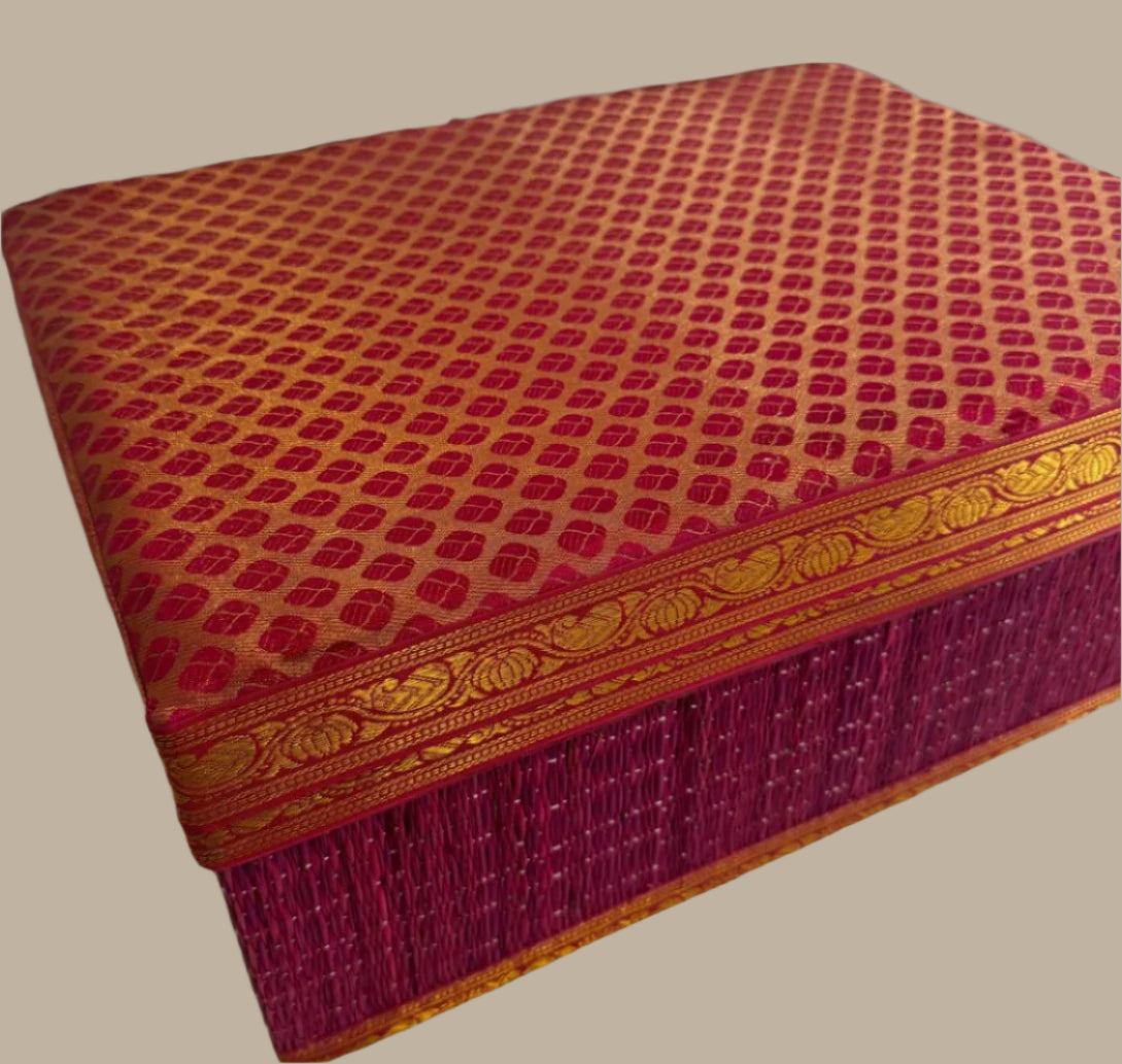 Decorative box with red and gold pattern on a gray background